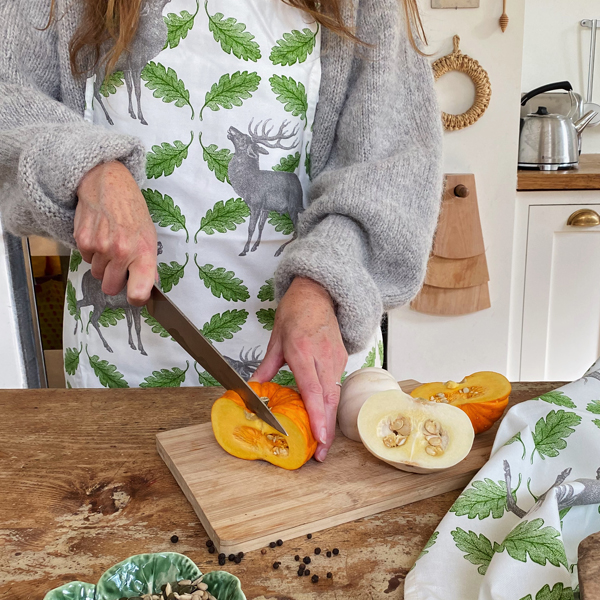 Chopping pumpkin with Stag & Oak apron